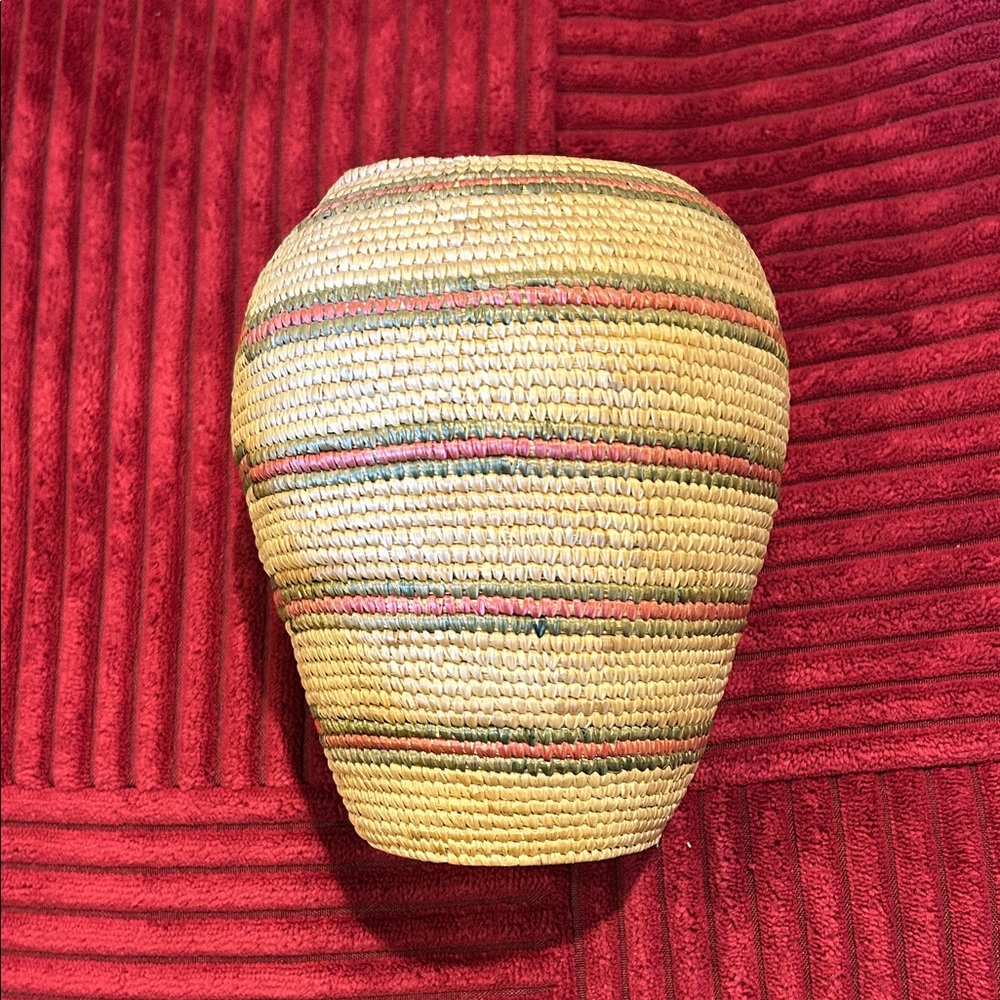 Woven basket with coral and green stripes